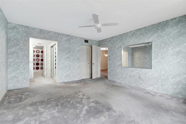 1001 Colony Point Cir Unit 220, Pembroke Pines, FL 33026 - spare room featuring ceiling fan, wallpapered walls, and concrete floors