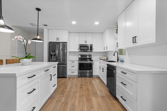 9360 SW 185th St, Cutler Bay, FL 33157 - kitchen with stainless steel appliances, recessed lighting, white cabinets, pendant lighting, and light countertops