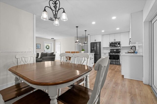 9360 SW 185th St, Cutler Bay, FL 33157 - dining space featuring light wood finished floors, a chandelier, and recessed lighting