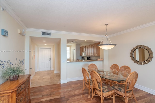 101 Gulfview Dr Unit 202, Key Colony, FL 33036 - dining room with ornamental molding and wood finished floors