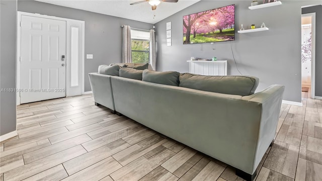 1226 SW Curry St, Port St Lucie, FL 34983 - living area featuring wood finished floors, a ceiling fan, and lofted ceiling