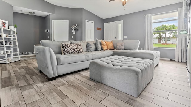1226 SW Curry St, Port St Lucie, FL 34983 - living room featuring a ceiling fan, vaulted ceiling, and light wood-style flooring