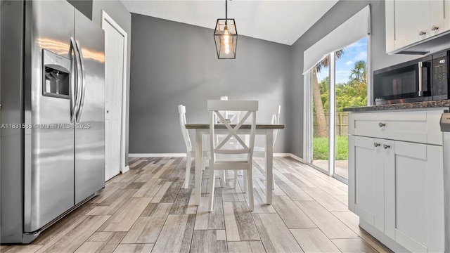 1226 SW Curry St, Port St Lucie, FL 34983 - unfurnished dining area with vaulted ceiling and light wood-style floors