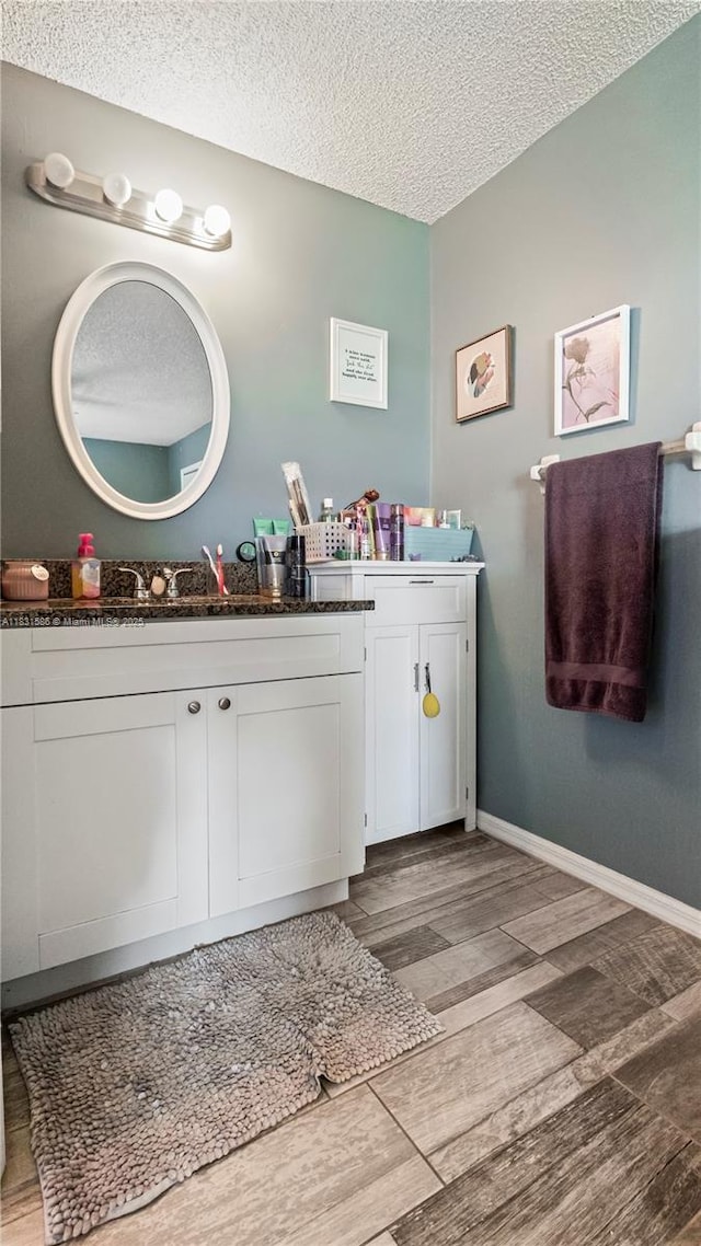 1226 SW Curry St, Port St Lucie, FL 34983 - bathroom featuring vanity, a textured ceiling, and wood finished floors