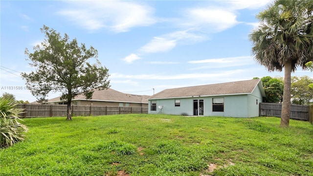 1226 SW Curry St, Port St Lucie, FL 34983 - back of property with a fenced backyard and stucco siding