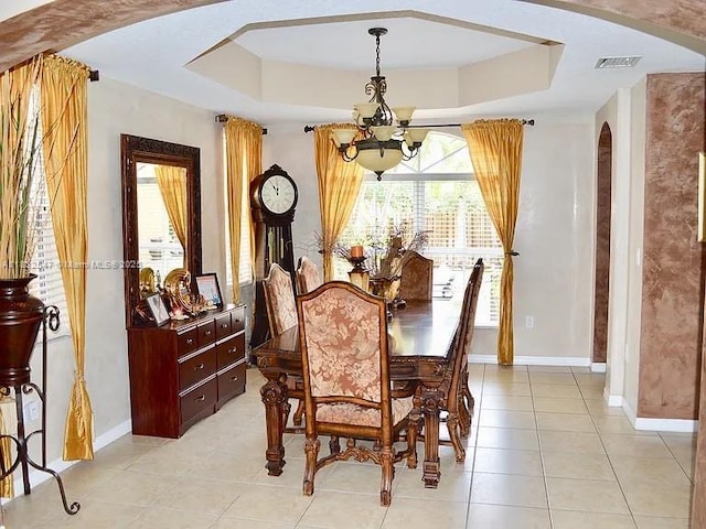 15601 SW 31st Ln, Miami, FL 33185 - dining area featuring arched walkways, a raised ceiling, a chandelier, and light tile patterned floors