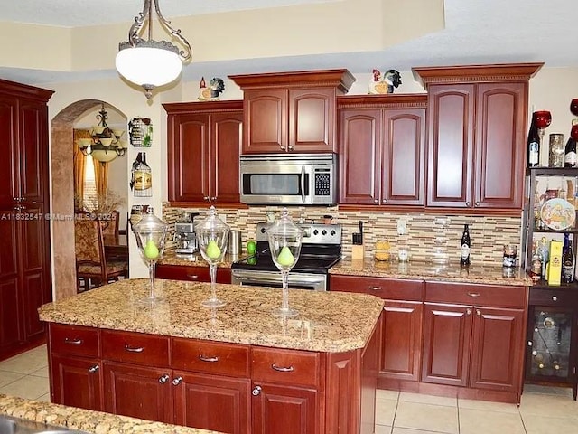 15601 SW 31st Ln, Miami, FL 33185 - kitchen featuring appliances with stainless steel finishes, reddish brown cabinets, and light tile patterned floors
