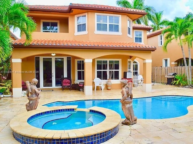 15601 SW 31st Ln, Miami, FL 33185 - rear view of property with french doors, a patio area, stucco siding, and a tiled roof