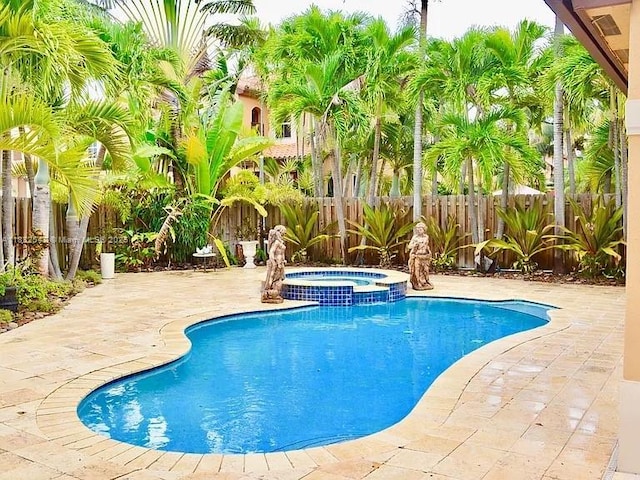 15601 SW 31st Ln, Miami, FL 33185 - view of pool featuring a patio, a fenced backyard, and a pool with connected hot tub