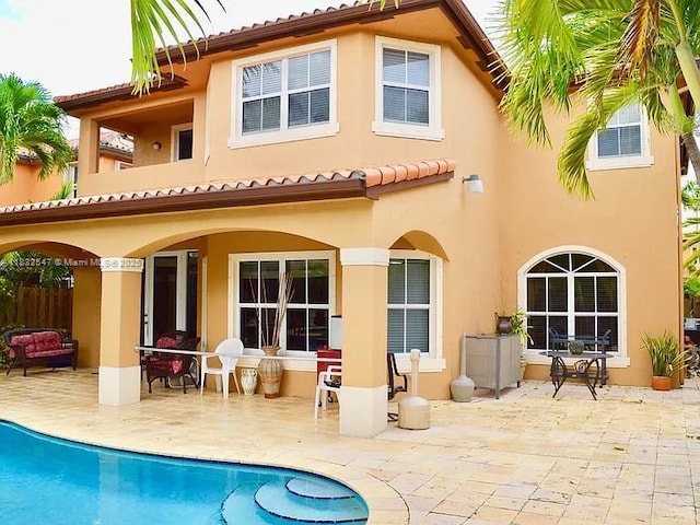 15601 SW 31st Ln, Miami, FL 33185 - rear view of house with stucco siding and a patio