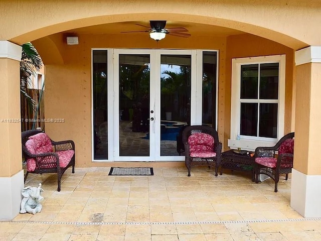 15601 SW 31st Ln, Miami, FL 33185 - view of exterior entry with french doors, a patio, stucco siding, and a ceiling fan