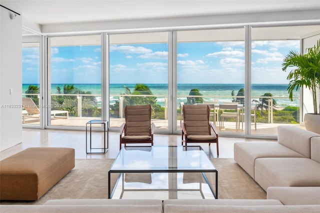 9001 Collins Ave Unit S-305, Surfside, FL 33154 - living room featuring healthy amount of natural light, a wall of windows, a water view, and tile patterned floors