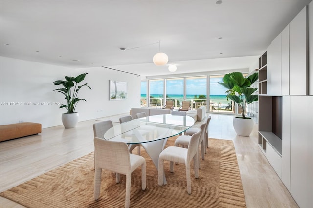 9001 Collins Ave Unit S-305, Surfside, FL 33154 - dining area with light wood-style flooring and a water view