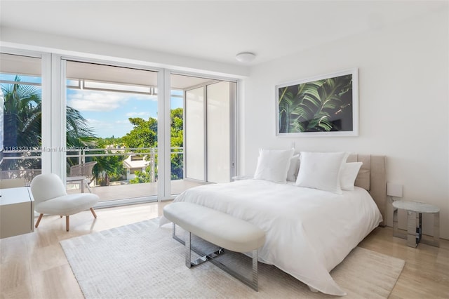 9001 Collins Ave Unit S-305, Surfside, FL 33154 - bedroom featuring access to exterior and light wood-type flooring
