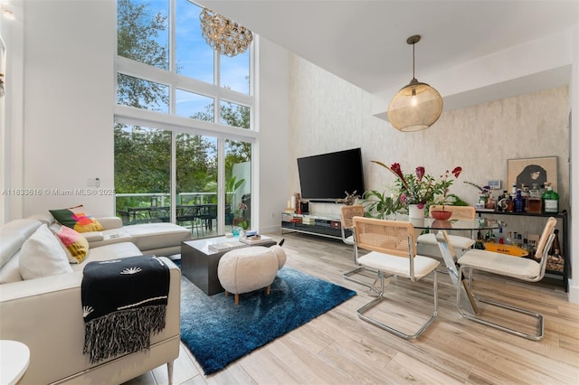 455 NE 39th St Unit 105, Miami, FL 33137 - living area featuring a high ceiling, wood finished floors, and wallpapered walls
