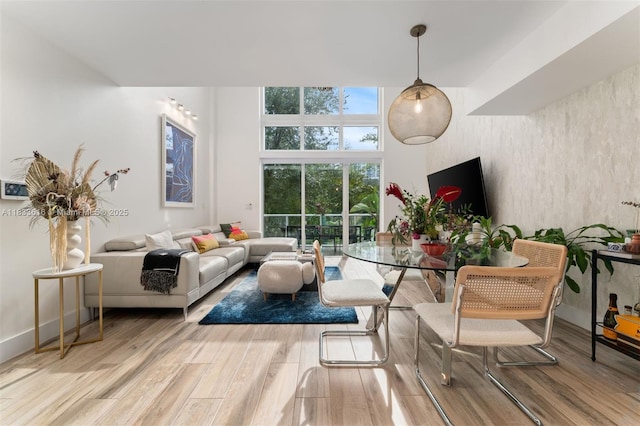 455 NE 39th St Unit 105, Miami, FL 33137 - dining area featuring wood finished floors and a high ceiling