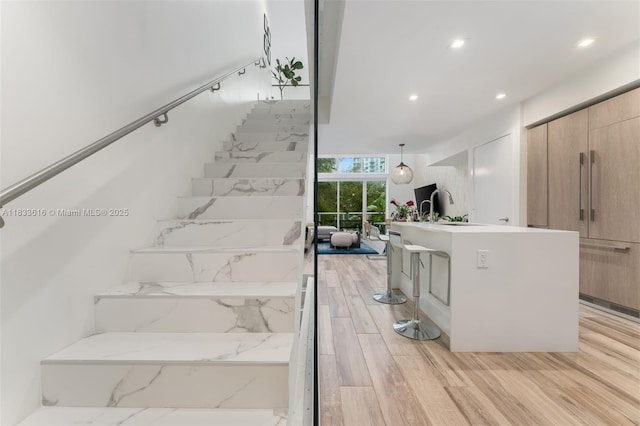 455 NE 39th St Unit 105, Miami, FL 33137 - stairway featuring wood finished floors, recessed lighting, and floor to ceiling windows