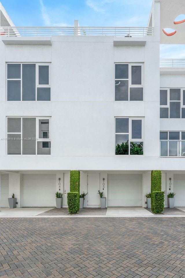 455 NE 39th St Unit 105, Miami, FL 33137 - view of front of home with stucco siding and a garage