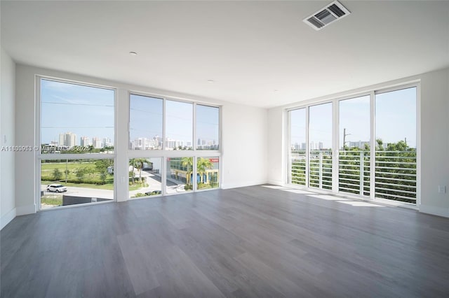 19380 NE 26th Ave Unit 304, Miami, FL 33180 - unfurnished room with wood finished floors, a city view, and expansive windows