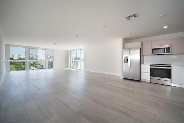 19380 NE 26th Ave Unit 304, Miami, FL 33180 - unfurnished living room featuring light wood-type flooring, recessed lighting, and a city view