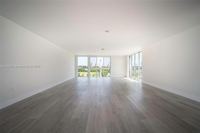 19380 NE 26th Ave Unit 304, Miami, FL 33180 - empty room with wood finished floors and a wall of windows
