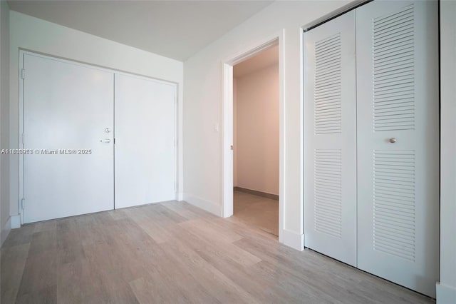 19380 NE 26th Ave Unit 304, Miami, FL 33180 - unfurnished bedroom with light wood-style floors and a closet
