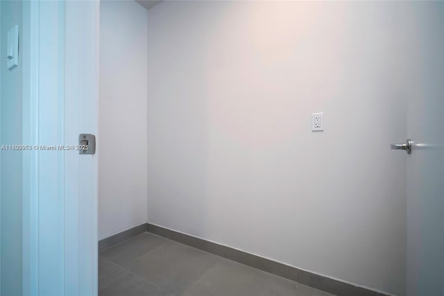 19380 NE 26th Ave Unit 304, Miami, FL 33180 - unfurnished room featuring baseboards and dark tile patterned flooring