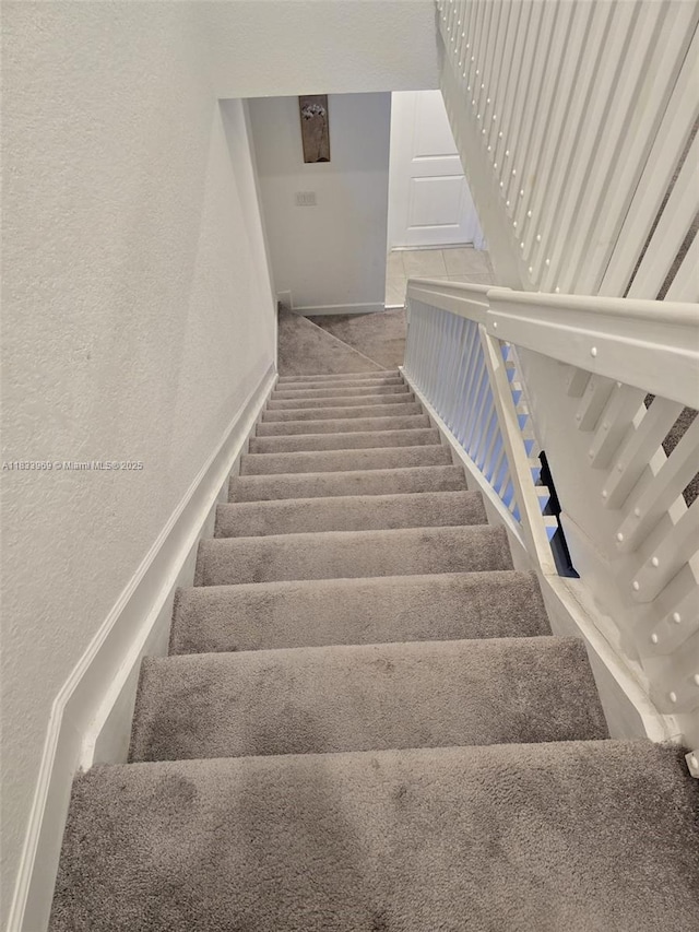 18264 SW 148th Rd Unit 18264, Miami, FL 33187 - staircase with a textured wall and baseboards