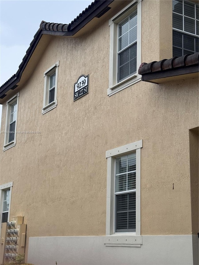 9239 SW 227th St, Cutler Bay, FL 33190 - view of side of home featuring stucco siding and a tiled roof