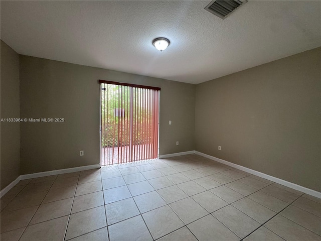 9239 SW 227th St, Cutler Bay, FL 33190 - spare room featuring light tile patterned flooring and a textured ceiling