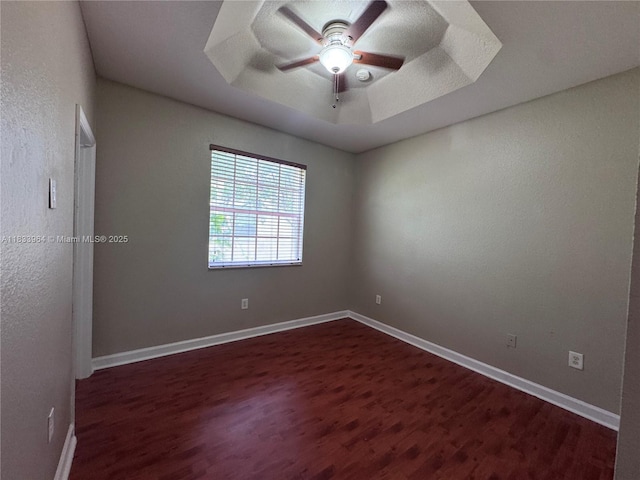 9239 SW 227th St, Cutler Bay, FL 33190 - spare room with dark wood-style floors, ceiling fan, and a tray ceiling