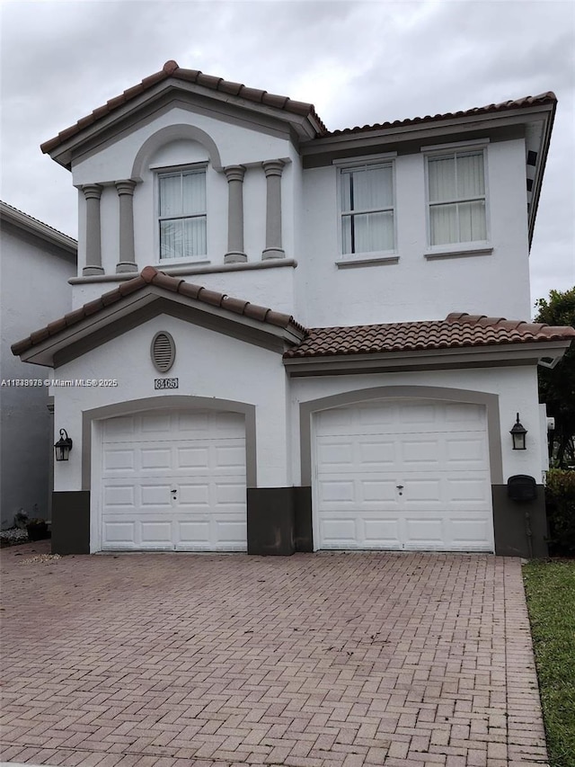 8465 NW 108th Path, Doral, FL 33178 - multi unit property with an attached garage, a tiled roof, stucco siding, and decorative driveway