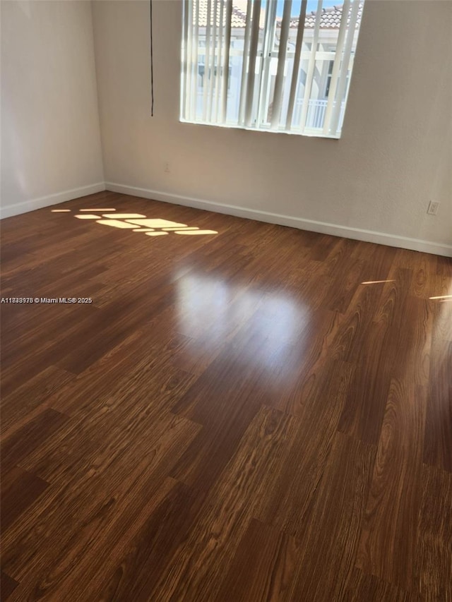 8465 NW 108th Path, Doral, FL 33178 - unfurnished room featuring baseboards and dark wood-style flooring