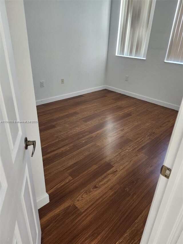 8465 NW 108th Path, Doral, FL 33178 - unfurnished room with dark wood-style floors and baseboards