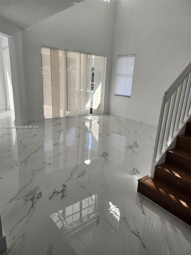 8465 NW 108th Path, Doral, FL 33178 - spare room featuring healthy amount of natural light, marble tiled flooring, and stairway