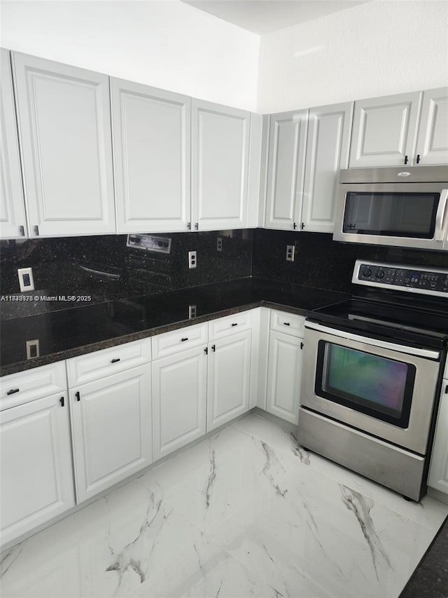 8465 NW 108th Path, Doral, FL 33178 - kitchen with stainless steel appliances, light marble finish flooring, and white cabinets