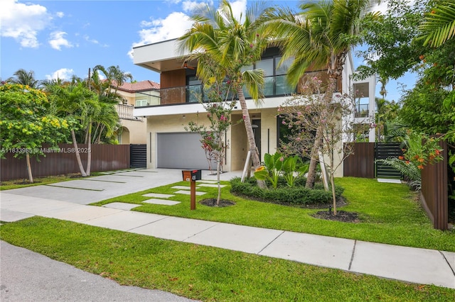 436 NE 10th Ave, Fort Lauderdale, FL 33301 - view of front of house featuring an attached garage, a balcony, concrete driveway, and stucco siding