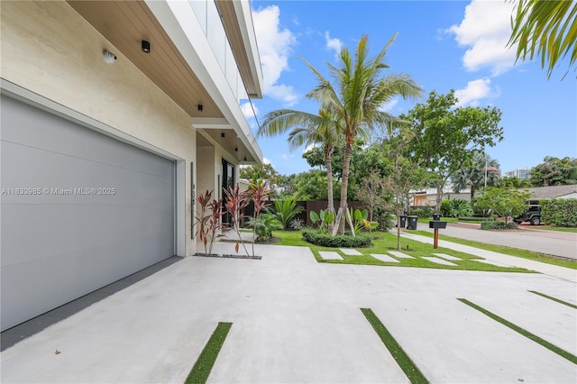 436 NE 10th Ave, Fort Lauderdale, FL 33301 - view of patio with a garage and concrete driveway