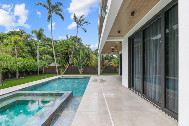 436 NE 10th Ave, Fort Lauderdale, FL 33301 - view of swimming pool with a patio, a fenced backyard, and a pool with connected hot tub