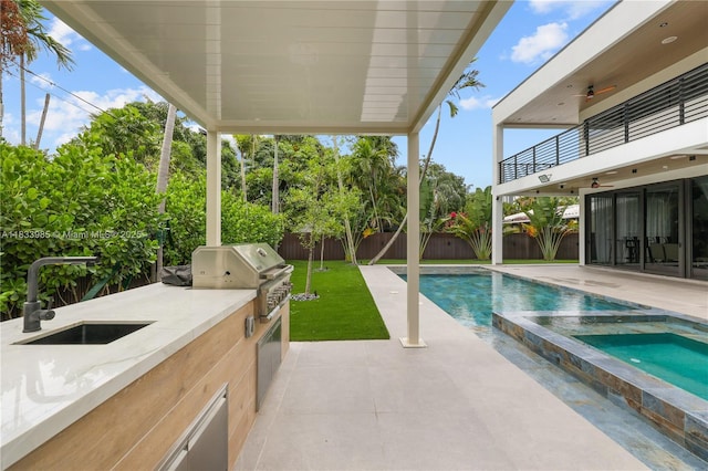 436 NE 10th Ave, Fort Lauderdale, FL 33301 - view of pool featuring an outdoor kitchen, a fenced backyard, a patio, ceiling fan, and a pool with connected hot tub