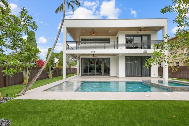 436 NE 10th Ave, Fort Lauderdale, FL 33301 - rear view of house featuring a balcony, a ceiling fan, a fenced backyard, stucco siding, and a patio area