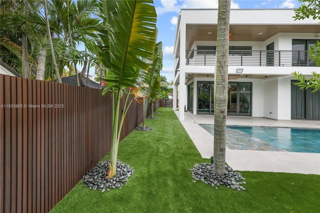 436 NE 10th Ave, Fort Lauderdale, FL 33301 - fenced backyard with a balcony, a patio area, ceiling fan, and french doors