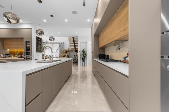 436 NE 10th Ave, Fort Lauderdale, FL 33301 - kitchen with modern cabinets, gray cabinets, light marble finish floors, recessed lighting, and a spacious island