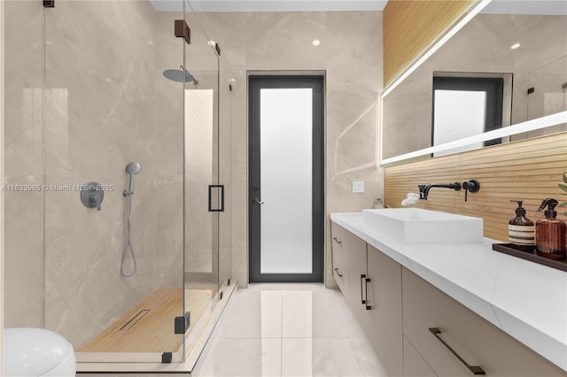 436 NE 10th Ave, Fort Lauderdale, FL 33301 - bathroom featuring vanity, a stall shower, tile walls, tile patterned flooring, and tasteful backsplash