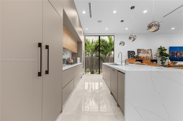 436 NE 10th Ave, Fort Lauderdale, FL 33301 - kitchen with modern cabinets, light marble finish floors, recessed lighting, a wall of windows, and pendant lighting