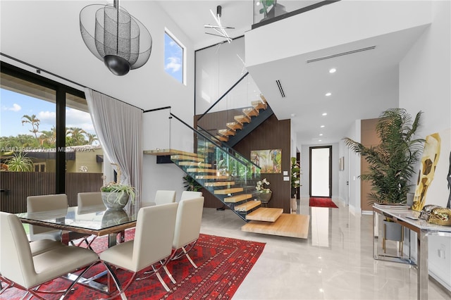 436 NE 10th Ave, Fort Lauderdale, FL 33301 - dining room featuring stairs, a high ceiling, marble tiled flooring, and recessed lighting