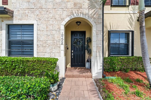 10468 W 33rd Ln, Hialeah, FL 33018 - doorway to property featuring stone siding