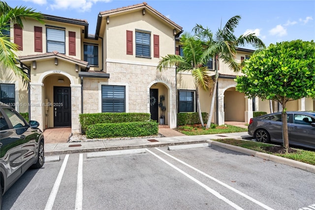 10468 W 33rd Ln, Hialeah, FL 33018 - townhome / multi-family property with stucco siding, stone siding, and uncovered parking