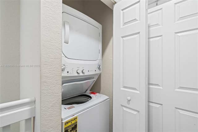 10468 W 33rd Ln, Hialeah, FL 33018 - laundry room with stacked washing machine and dryer and a textured wall
