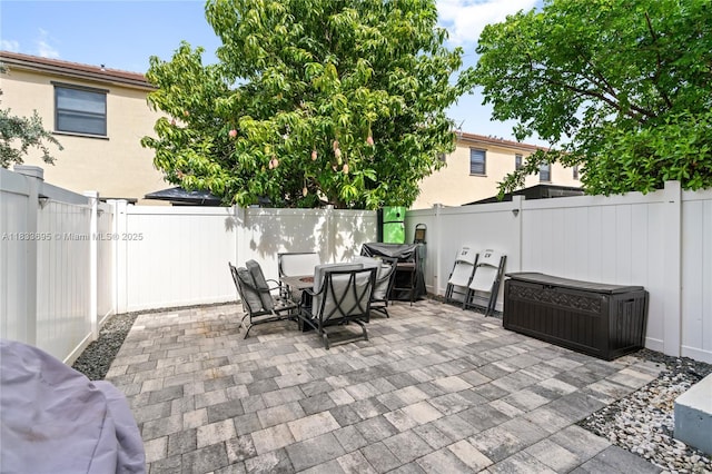 10468 W 33rd Ln, Hialeah, FL 33018 - fenced backyard with a patio area, outdoor dining area, and a grill